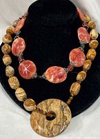 Two gemstone bead necklaces on display bust showing overall appearance