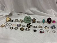 Full group of 30 rings laid out on cloth