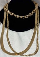 All three gold-tone chains displayed on bust