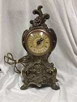 Front view of ornate electric mantel clock