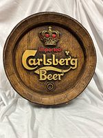 Front view showing full logo and crown on barrel-top sign