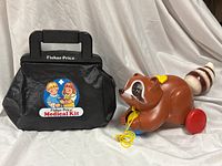 Raccoon pull toy and Medical Kit bag together