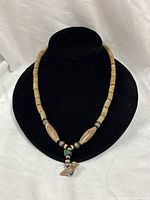 Full view of necklace on display bust showing bead pattern and length