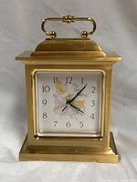 Front view of brass carriage clock showing full case and dial