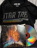 T-shirt laid flat with LaserDisc sleeve and disc showing