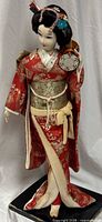 Full view of geisha doll on stand