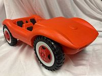 Front three-quarter view of orange sports car