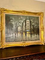 Frontal view of framed A. Petrin painting on stand