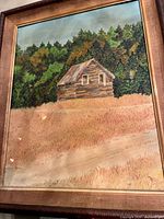 Full view of framed painting with barn, field, trees