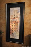 Full view of framed vertical watercolor painting in black frame