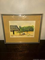 Front view of framed painting in mat and metal frame