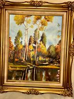 Front view of framed oil landscape painting