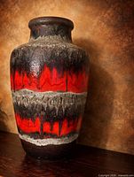 Full view of tall West German lava glaze vase with red, black and grey drip finish
