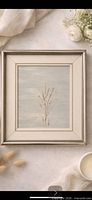 Full view of framed artwork showing minimalist botanical subject and matting