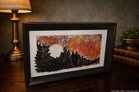 Front view of framed mixed-media artwork showing texture, colors and frame