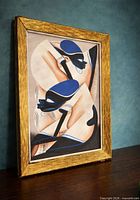 Framed modernist artwork angled on tabletop