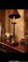 Full view of brass and wood lamp on table with shade