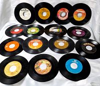 Overhead view of all 16 singles showing assorted labels and condition