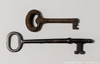 Top view of both antique iron keys showing overall form