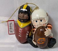 Front view of both ornaments showing team logos and attached tags