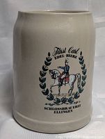 Front view of German stoneware beer mug showing full crest and text