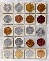 Full page showing all 20 Mardi Gras coins in holders