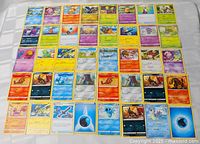 Overhead view of 40 assorted Pokémon cards laid out in 5 rows