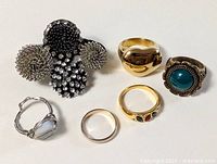 All six costume rings laid out for scale and style overview