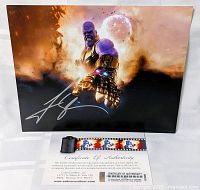 Signed Thanos photo displayed upright with COA and film cell below