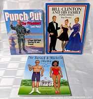 Front covers of the three paper doll books