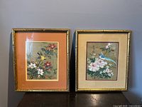 Both framed paintings side by side