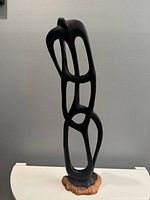 Full view of ebony abstract Ujamaa sculpture on base