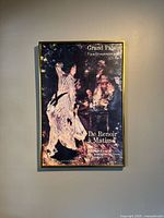 Front view of framed exhibition poster on wall