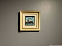 Framed painting hanging on wall, showing full frame and scale