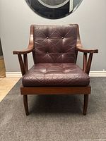 Front view showing leather cushions, frame, legs