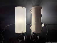 Front view of both Ikea Smyg wall lamps showing design and condition