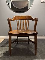 Front view showing overall design, arms, spindle back and seat