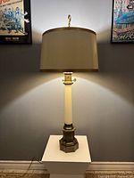 Full view of lamp lit, showing shade, column, base and finial