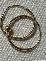 Pair of 10k yellow gold hoop earrings showing overall design