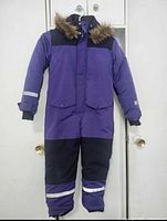 Front view of purple and black girls snowsuit with faux fur hood and reflective strips