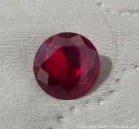Top view of red faceted round gemstone