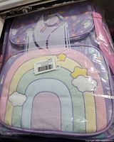 Packaged three-piece backpack set showing rainbow front pocket