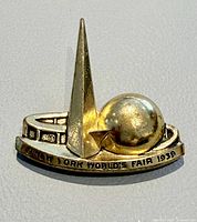 Front view of brooch showing Trylon, Perisphere and inscription