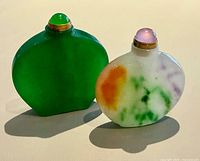 Front view of both jade snuff bottles standing