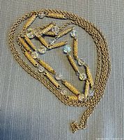 Full view of coiled necklace showing chains, spacers, and beads
