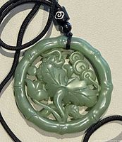 Front view showing frog and lotus carving inside bamboo-style rim