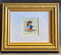 Front view of framed Mickey Mouse etching in gold frame