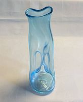 Full view of blue art glass vase standing upright