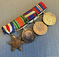 Front view of four WWII medals on ribbon bar