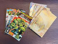 Nine comics arranged showing covers of The Toxic Avenger and TMNT